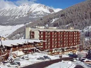 a large building in the snow in front of a mountain at Appartement Vars, 3 pièces, 8 personnes - FR-1-330B-146 in Vars