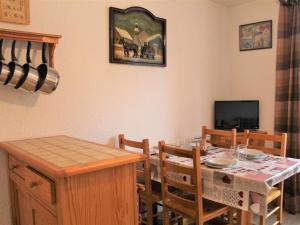 une salle à manger avec une table et une télévision dans l'établissement Appartement Vars, 1 pièce, 4 personnes - FR-1-330B-140, à Vars