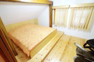 a small bed in a room with a wooden floor at Holiday home in Crnomelj - Kranjska Krain 35279 in Črnomelj