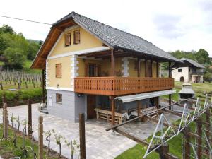 a small house with a large deck on a patio at Holiday home in Crnomelj - Kranjska Krain 35279 in Črnomelj