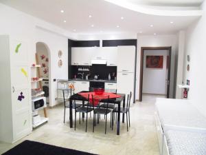 a kitchen and dining room with a table and chairs at Roma For You in Rome