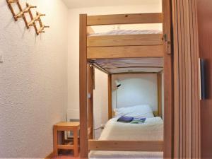 a wooden bunk bed in a room with a bed at Appartement Risoul, 2 pièces, 6 personnes - FR-1-330-495 in Risoul