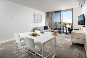 a living room with a white table and chairs at Quest Midland in Midland Junction