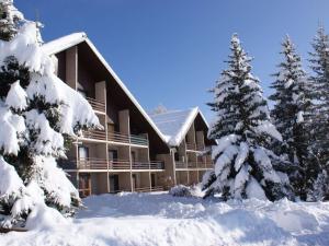 a building covered in snow in front of trees at Studio Saint-Michel-de-Chaillol, 1 pièce, 4 personnes - FR-1-393-131 in Saint-Michel-de-Chaillol