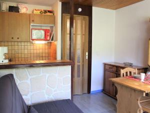 a kitchen with a counter and a table in it at Appartement Vars, 1 pièce, 4 personnes - FR-1-330B-85 in Vars