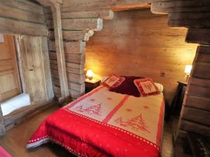 a bedroom with a bed in a log cabin at Chalet Arêches-Beaufort, 4 pièces, 6 personnes - FR-1-342-158 in Beaufort