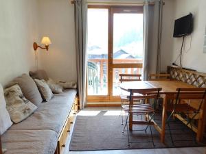 a living room with a couch and a table at Appartement Arêches-Beaufort, 2 pièces, 4 personnes - FR-1-342-173 in Arêches-Beaufort