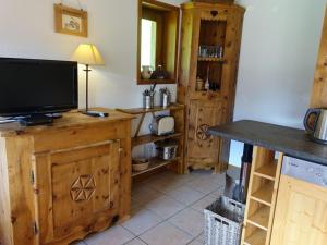 a living room with a television on a wooden cabinet at Duplex ski aux pieds pour 6 pers, bien équipé - FR-1-342-193 in Beaufort