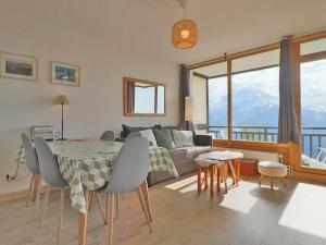 a living room with a table and a couch at Appartement Montvalezan-La Rosière, 3 pièces, 6 personnes - FR-1-398-609 in Montvalezan