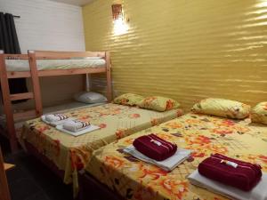 two beds in a room with towels on them at Pousada Caminho das Dunas in Cumbuco