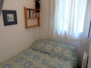 a bedroom with a bed and a window and a book shelf at Appartement Arêches-Beaufort, 3 pièces, 6 personnes - FR-1-342-152 in Arêches-Beaufort