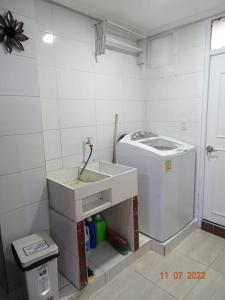 a kitchen with a sink and a washing machine at Acogedor apartamento en Fusagasugá in Fusagasuga