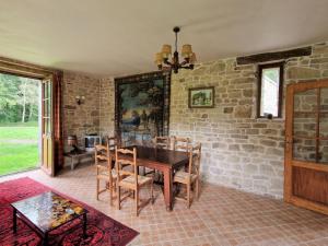 a dining room with a table and a brick wall at Apartment in Bénodet near Sandy Beaches in Bénodet