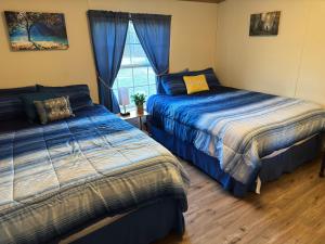 a bedroom with two beds and a window at Spacious Cozy Getaway ! King Bed, Game Room, Out Door Patio in Cairo