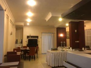 a kitchen and dining room with a table and chairs at Hotel Monika in Rantepao