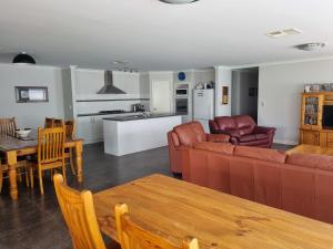 a living room with a couch and a table at Busselton Broadwater Holiday Home in Busselton