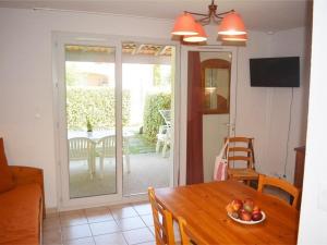 a dining room with a table and a sliding glass door at Maison Duplex 6 Pers. avec Terrasse, Piscine Chauffée et Climatiseur - FR-1-382-121 in Vallon-Pont-dʼArc