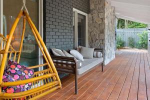 a porch with a couch and a swing at Endless Somers in Somers