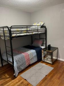 a bedroom with two bunk beds and a table at Gorgeous 3 Bdrm vacation house in Detroit