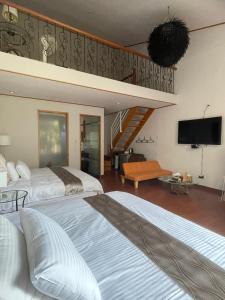 a hotel room with two beds and a tv at Deng Mei Homestay in Hengshan