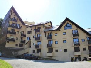 a large building with a car parked in front of it at Appartement Vars, 1 pièce, 4 personnes - FR-1-330B-68 in Vars