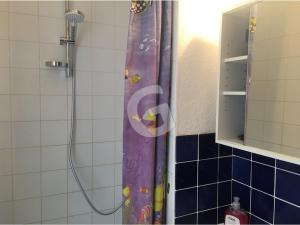 a shower curtain with a cartoon characters on it in a bathroom at Studio idéal au centre-ville de La Tranche-sur-Mer, à 80m de la plage, avec balcon et aperçu mer - FR-1-357-240 in La Tranche-sur-Mer