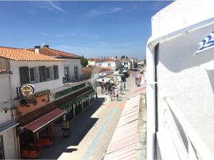 a view of a street with people walking on the sidewalk at Studio idéal au centre-ville de La Tranche-sur-Mer, à 80m de la plage, avec balcon et aperçu mer - FR-1-357-240 in La Tranche-sur-Mer +7 photos