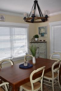 a dining room with a wooden table and chairs at In the heart of West Palm Beach, pets welcome in West Palm Beach