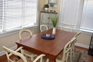 a wooden table with chairs and a blue plate on it at In the heart of West Palm Beach, pets welcome in West Palm Beach