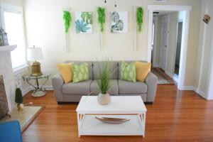 a living room with a couch and a table at In the heart of West Palm Beach, pets welcome in West Palm Beach