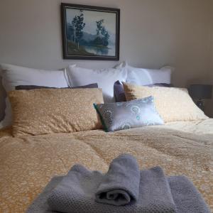 Una cama con un montón de toallas. en Hillview Homestay, en Richmond