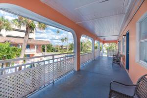 a balcony with a view of the ocean and palm trees at Echo Sails Motel in Clearwater Beach