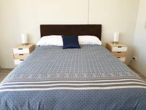 a bedroom with a large bed with two night stands at Waverley apartment E-one bedroom wifi available in Perth