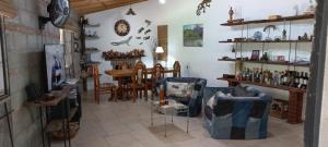 a living room with a table and chairs in a room at La Chelca in San Fernando del Valle de Catamarca