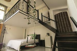 a bedroom with a bed and a staircase in a room at Deng Mei Homestay in Hengshan
