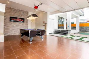 a pool table in the middle of a living room at 3BD Pool Villa Pattaya with sauna - Exquisite Pool Villa B in Nong Prue