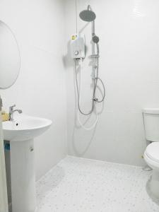 a shower in a bathroom with a sink and a toilet at หมอกยามเช้า กะปง รีสอร์ท in Ban Mo