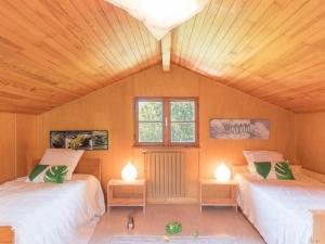 a room with two beds and two lamps in it at Chalet Puy Saint Vincent 1400, 5 pièces, 8 personnes - FR-1-330G-60 in Les Prés