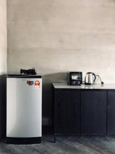 a small refrigerator next to a counter with a radio at 80 Colonie Fraser's Hill 16 Pax in Bukit Fraser