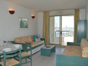 a living room with a couch and a table at Fréjus: Appt 2P, 5 pers, Piscine, Plage à 150m, Parking, Animaux OK - FR-1-226A-357 in Fréjus