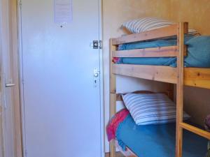a bunk bed with pillows on the bottom bunk at Appartement Le Lavandou, 1 pièce, 4 personnes - FR-1-251-232 in Le Lavandou