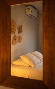 a mirror reflection of a bed in a bedroom at Villa Cordel in Fernando de Noronha