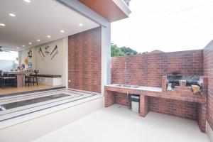 a brick wall with a sink next to a patio at Pattaya Pool Villa-Exquisite Pool Villa H in Nong Prue