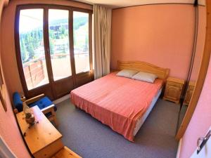 a bedroom with a bed and a large window at Appartement Vars, 2 pièces, 4 personnes - FR-1-330B-63 in Vars