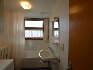 a bathroom with a sink and a tub and a window at Appartement Le Grand-Bornand, 3 pièces, 6 personnes - FR-1-241-189 in Le Grand-Bornand