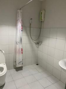 a bathroom with a shower and a toilet at Pupha Mansion in Chaweng Noi Beach