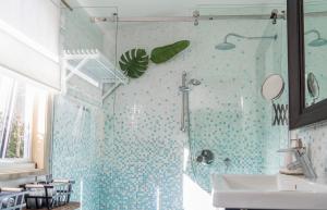 a bathroom with a shower and a sink at The White Cottage Byron Bay in Suffolk Park