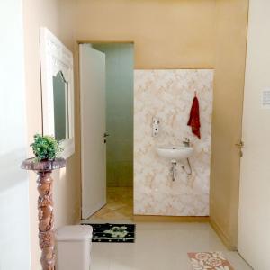 a bathroom with a sink and a mirror at Mutiara Balecatur Guest House in Yogyakarta