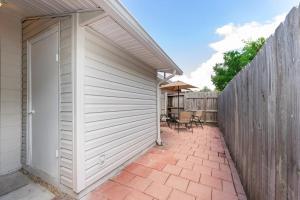 a white garage door next to a wooden fence at Adorable 2bed1bath Unit Sleeps 4 Close To Town Center Downtown Beach Mayo Clinic in Jacksonville