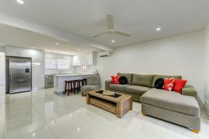 a living room with a couch and a table at Unit 3 Everdell Street in Bargara